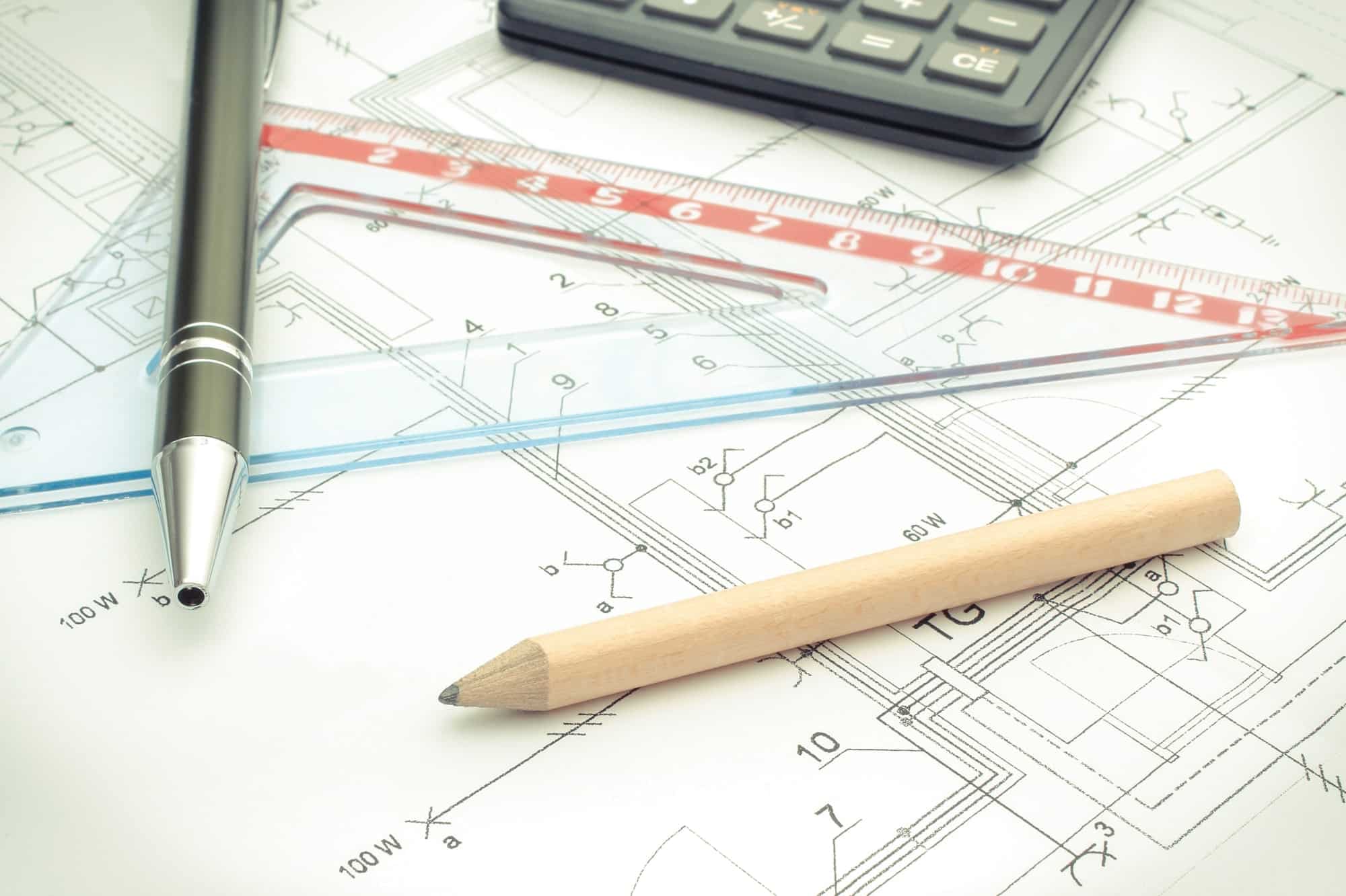 Drawing accesories and calculator on housing plan, building home cost concept